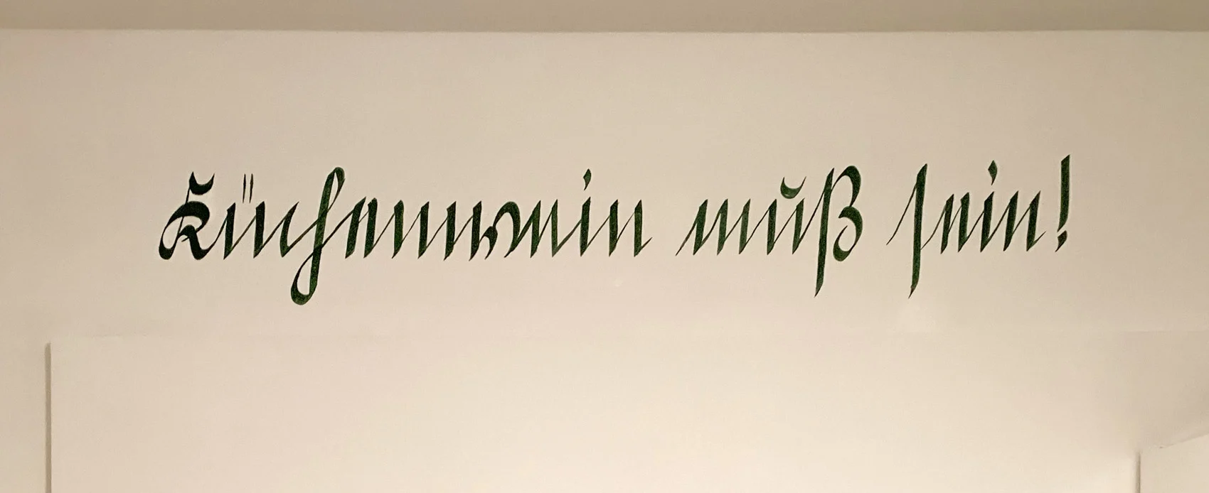 Mit dem Pinsel geschriebener Satz Küchenwein muss sein in Kurrentschrift